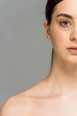 cropped view of young naked woman with marks on face looking at camera isolated on grey