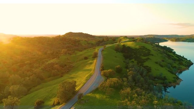 Aerial View  Dam Village waterfront  4K Helicopter Shot  landmark trees road cars cloudes california lake