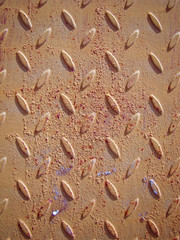 Сorrugated metal with a symmetrical pattern - lentil. Coated with yellow paint with traces of corrosion, rust, swelling, paint spills, chips. Vertical image.