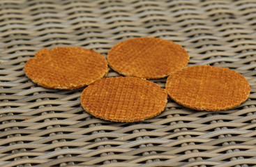 stack of traditional dutch stroopwafels cookie, a caramel syrup waffle, on wooden background
