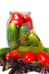 Glass can with tomatoes, cucumbers and spices isolated on the white background