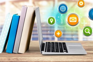 Laptop and books isolated on white background. Modern education and on-line learning