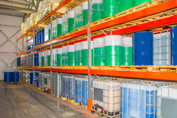 Industrial storage. Plastic chemical tanks are on the shelves. Barrels for toxic substances....