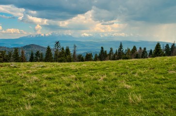Beautiful mountain spring landscape. Beautiful peaks and charming valleys and hills.