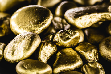 gold texture, many gold nugget, stone of value. Crude gold drawn on black background. Concept of wealth or luxury.
