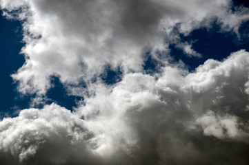 rain clouds in the blue sky on a sunny summer day
