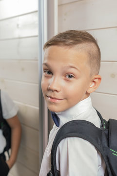 A 10-year-old boy prepares for school after a long summer break. Back to school. In front of the mirror.