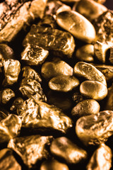 gold texture, many gold nugget, stone of value. Crude gold drawn on black background. Concept of wealth or luxury.
