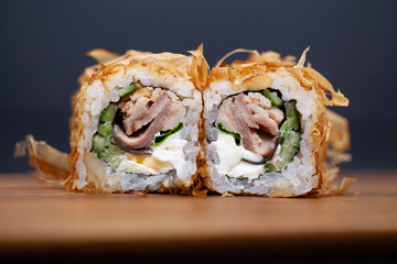 Japanese Sushi roll with salmon and cucumber on dark background