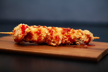 Barbecue with meat and vegetables on a dark background.