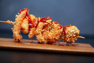 Barbecue with meat and vegetables on a dark background.