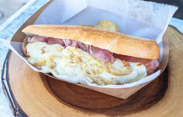 Huge melted cheese sandwich with hum.  Fast food concept.