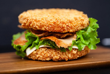 Sushi Burger with a variety of tasty ingredients on a dark background