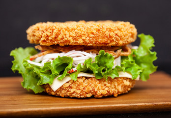 Sushi Burger with a variety of tasty ingredients on a dark background