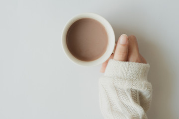 hands holding cup of coffee on white background