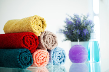 Colored towels on white table with copy space on bath room background