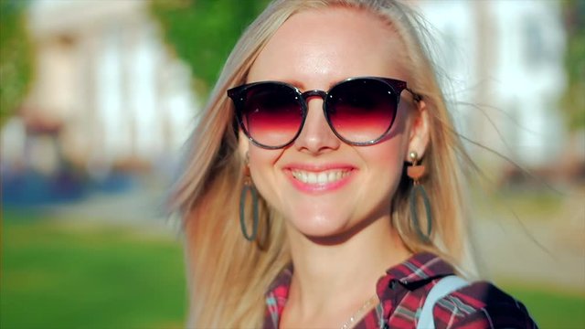 Portrait of European Cute Blonde in with Sunglass Young Happy Woman or Cheerful Girl Looking in The Camera, Blowing Wind Hair the Wind , Slow Motion.