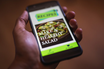 hand holding phone . online cooking blog . recipes channel