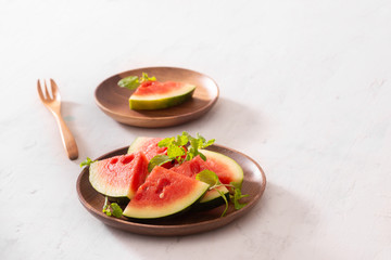 Red watermelon sliced ​​on a wood plate