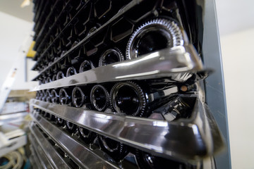 Many bottles of wine are on the shelves on top of each other - Side view wide angle