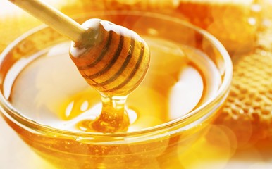 Honey with spoon in glass bowl