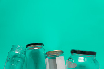 Isolated glass jars, flat on teal mint green background, room for copy space top