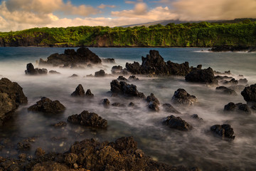Fototapeta na wymiar Rocky Maui shoreline with cliffs and sea stacks at sunset - Hawaii, USA