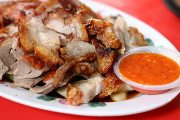 Chinese roasted pork with spicy chili sauce,one of popular food at Petaling street in Kuala Lumpur's Chinatown, Malaysia. This area has dozens restaurants and food stalls, serving best local dishes.