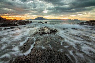 Fototapeta premium Sea dawn with waves and rocks at nha trang