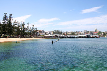 Fototapeta na wymiar Looking across the swimming beach to Manly ferry wharf. Australia.