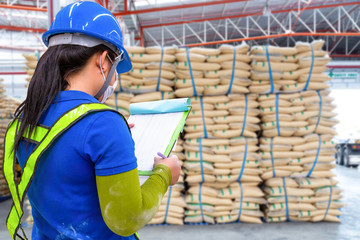 stacked sacks of sugar in warehouse waiting for transportation