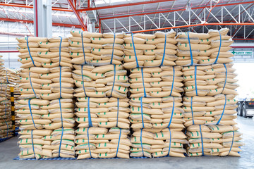stacked sacks of sugar in warehouse waiting for transportation