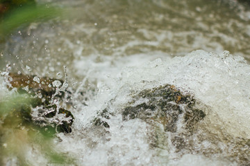  splashes of water in a turbulent mountain river. water splash close up