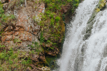  waterfall in the mountains. green stones