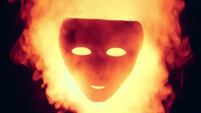 Human mask in the red fire