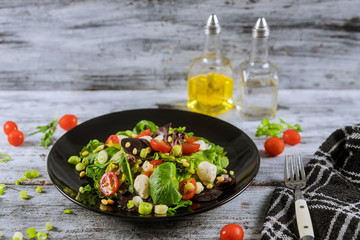 Vegetarian food ingredients for salad with mozzarella, arugula and cherry tomatoes.