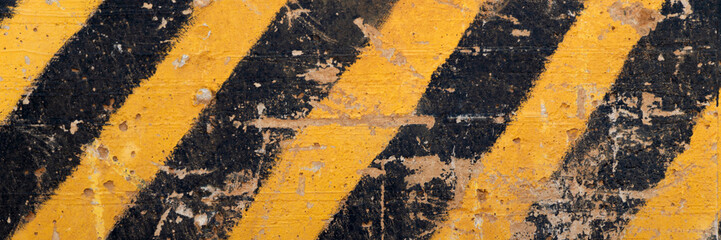 danger zone sign - black and yellow stripes, dirt and sand