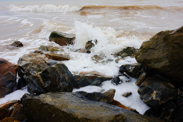 The stony shore of the stormy sea.