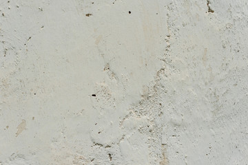 Fototapeta premium Texture of a concrete wall with cracks and scratches which can be used as a background