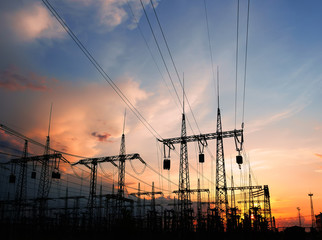 High-voltage power lines on the background of a beautiful cloudy sunset sky.