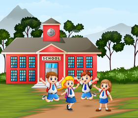 Fototapeta na wymiar Happy children with backpack on school building background