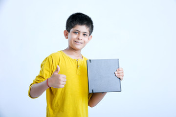 young indian boy showing notebook 