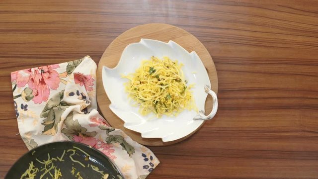 Serving sevai(vermicelli) upma in a plate. Sevai upma is a very famous breakfast dish in south India. 