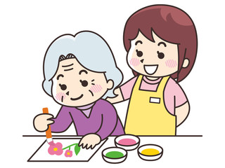 塗り絵を楽しむ高齢女性と介護士の女性