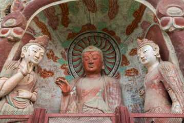 Sculpture of Buddha and Bodhisattva with colorful fresco in right niche at verandah of Grotto 5 at Mount Maiji or Maijishan Grottoes, Tianshui, Gansu, China. Constructed from late fourth century CE.