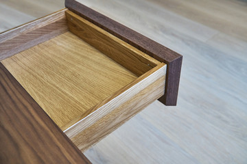 Open drawer of wooden table in office