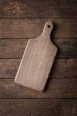 Fototapeta premium Vintage cutting board on wooden background