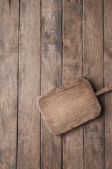 Rustic cutting board on wooden table with copyspace