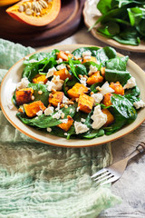 Roasted pumpkin salad with spinach and nuts