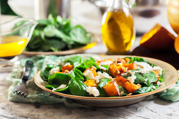 Roasted pumpkin salad with spinach and nuts